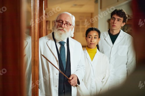 Preview: Senior Caucasian Man Teaching Diverse Young Adults in Medical Training Setting