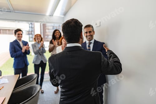 Preview: Business team congratulating their coworker for his success