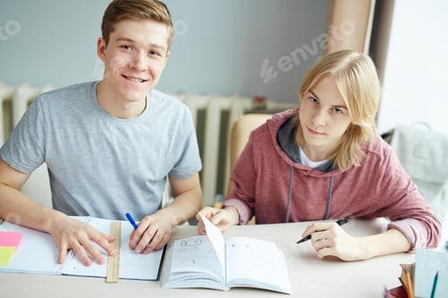 Preview: Smiling Young Men Study Together at Table