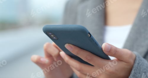 Preview: Business woman look at mobile phone