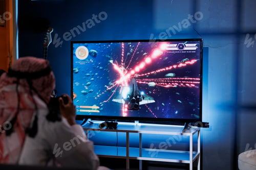 Preview: Arab man playing a game on television
