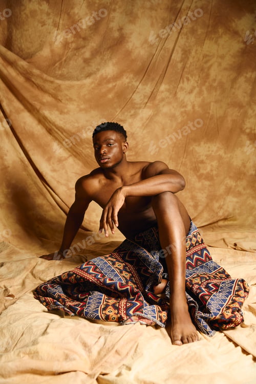 Preview: Young handsome man exudes confidence in artistic pose against abstract backdrop