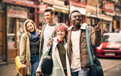 Preview: Happy multiracial friends walking on Brick Lane at Shoreditch London