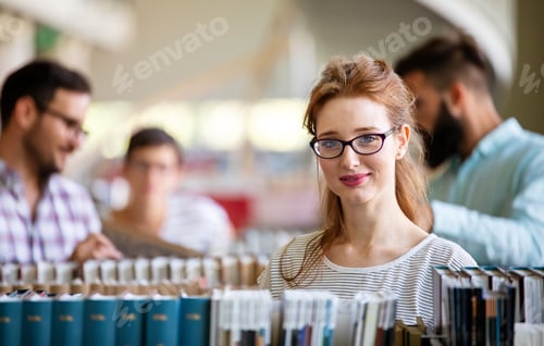 Preview: Happy group of students studying and working together in a college library