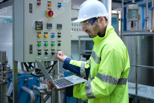 Preview: Engineer specialist using laptop checking and maintaining machine in factory