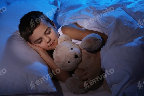 Preview: Little boy sleeping with teddy bear at home. Bedtime