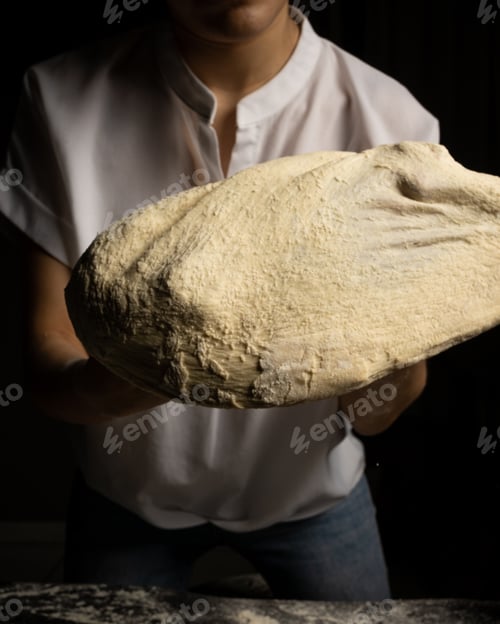 Preview: Lady chef making pizza dough, stretching dough