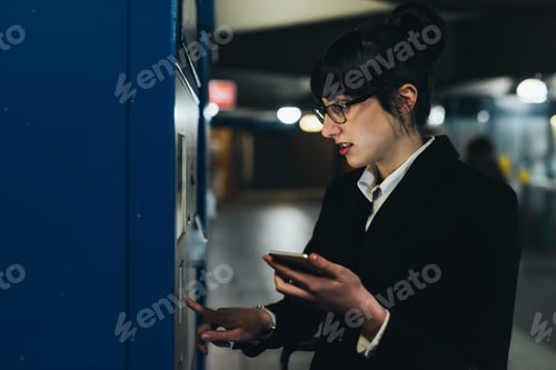 Preview: Businesswoman using ticket machine, Milan, Italy