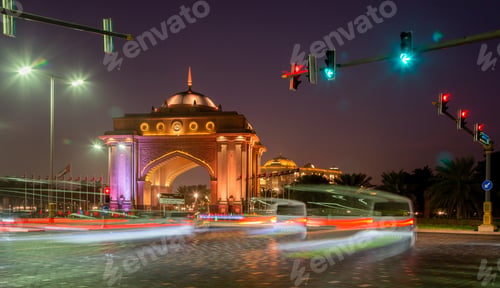 Preview: Street at night in Abu Dhabi, road with moving cars and Emirates Palace at the background