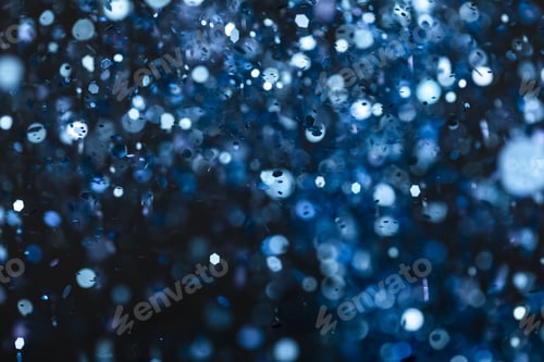 Preview: Beautiful blue bokeh lights and glitters on a black background