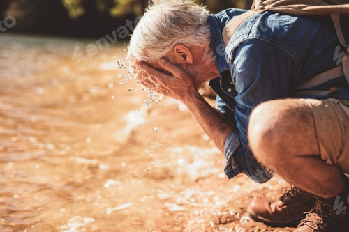 Preview: Mature man getting fresh during a hike