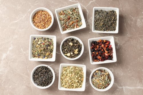 Preview: Flat lay with different types of tea on textured background