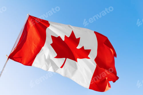 Preview: Flag of Canada waving against blue sky