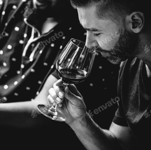 Preview: Man tasting red wine with friends