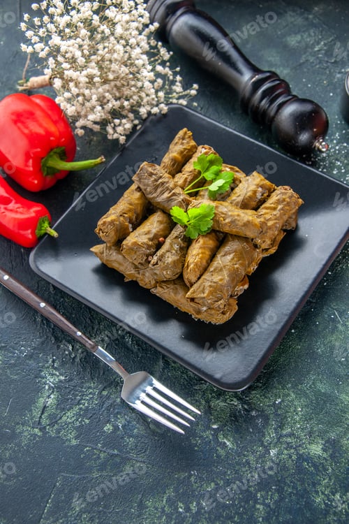Preview: front view tasty leaf dolma with seasonings on dark background oil dinner food restaurant salad