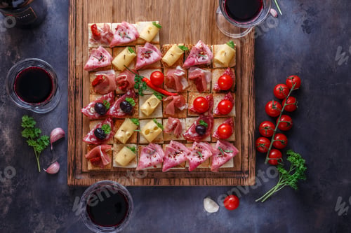 Preview: Tasty Italian appetizers, or bruschetta, slices of toasted baguette topped with ham, prosciutto