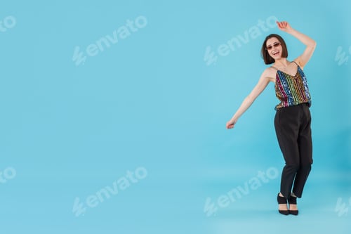 Preview: Happy woman dancing on light blue background. Space for text