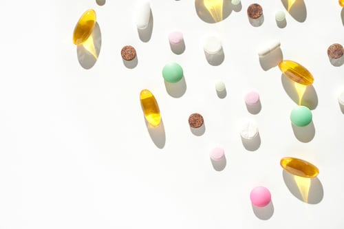 Preview: Colorful assortment of various pills and capsules on white background