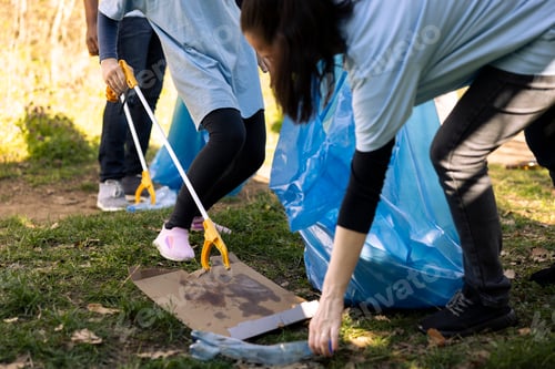 Preview: Child and woman grabbing junk and plastic from the ground
