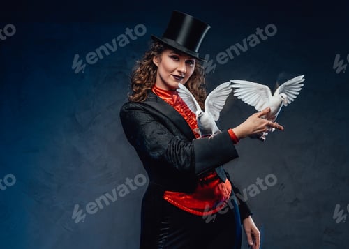 Preview: Caucasian female artist dressed in costume with top hat and doves