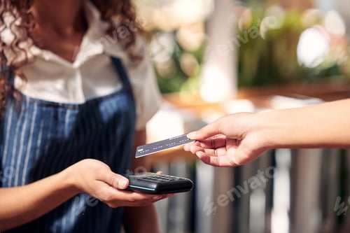 Preview: Oh, definitely tap. Shot of a customer using a card and an NFC scanner to make a card payment.