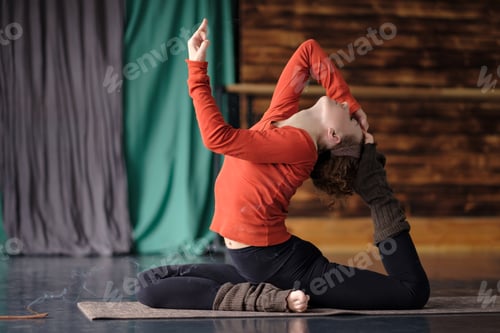 Preview: Young sporty woman practicing yoga, doing Eka Pada Rajakapotasana pose