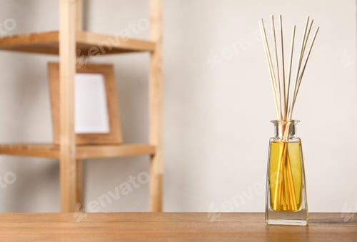 Preview: Reed air freshener on wooden table indoors, space for text