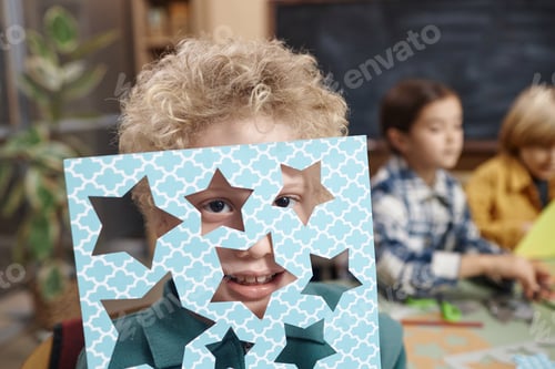 Preview: Little boy peeking though star cutouts
