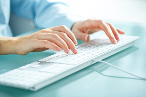 Preview: Woman office worker typing on the keyboard