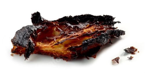 Preview: burned croissant on a white background