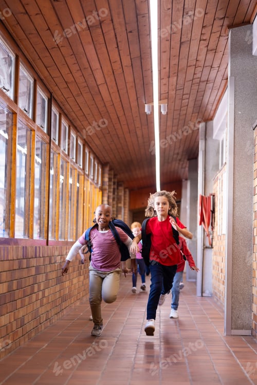 Preview: Running in school hallway, diverse children with backpacks enjoying recess time, copy space