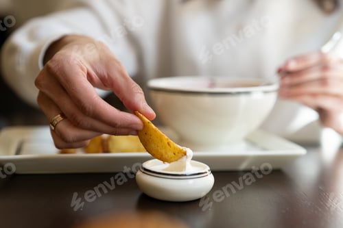 Preview: Female is ready to eat a tasty fried potato dipping in a delicate sauce