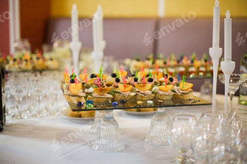 Preview: Buffet Food Closeup. meat, fish, vegetable canapés on a festive wedding table outdoor