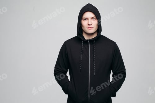 Preview: Serious athletic man in black hoodie