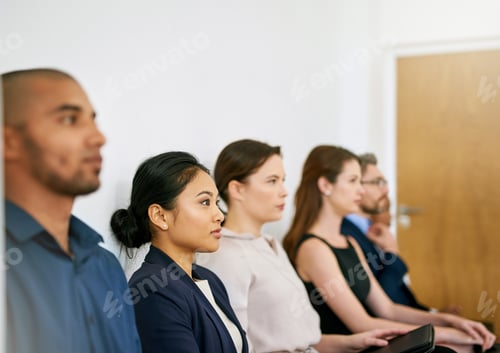 Preview: Ready to impress. Shot of a group of businesspeople seated in line while waiting to be interviewed.