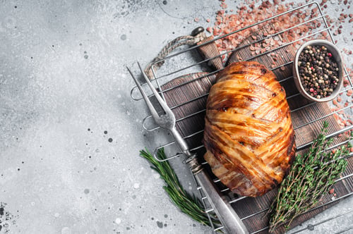 Preview: Baked meatloaf with bacon, meat loaf on a grill. Gray background. Top view. Copy space
