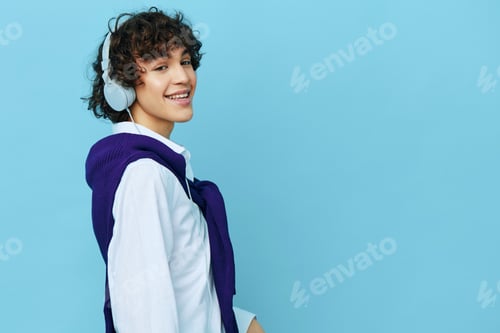 Preview: teenager technology headphones in a white shirt with sweater isolated backgrounds