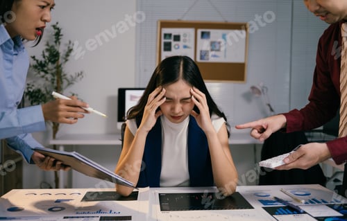 Preview: Asian businesspeople are blaming their colleague for bad results in the office at night, she is havi