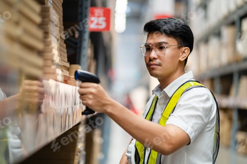 Preview: Male warehouse worker scanning barcodes on boxes in a warehouse.