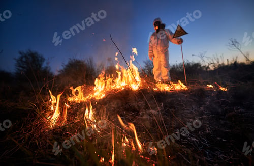 Preview: Firefighter ecologist working in field with wildfire.