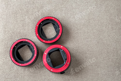 Preview: Close-up of macro rings, camera adapters on light cloth copy space background