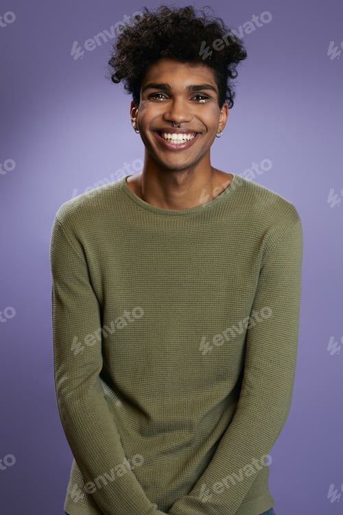 Preview: Portrait of transgender brunette model in olive t-shirt looks camera and smile