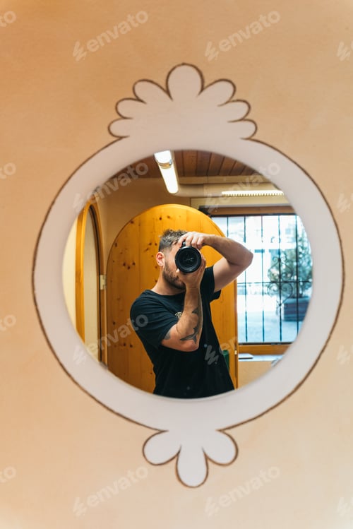 Preview: Photographer taking a picture of himself reflected in a mirror