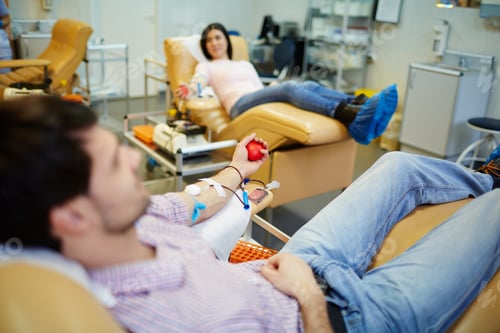 Adults Donating Blood at Modern Medical Facility