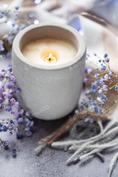 Preview: Candle and a branch of gypsophila flowers