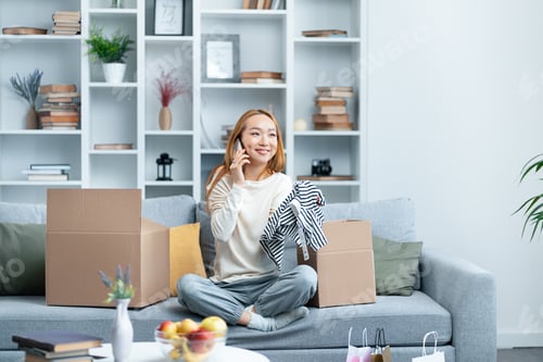 Preview: Woman Unpacking Boxes In New Apartment, Phone Call