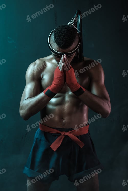 Preview: Muay Thai athlete training at Thai boxing indoors, ultimate fight concept