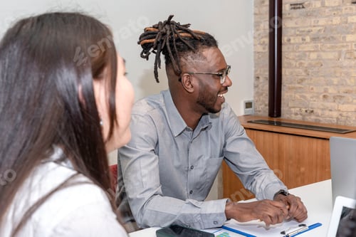 Preview: close-up of a smiling African-American man seated in a meeting room