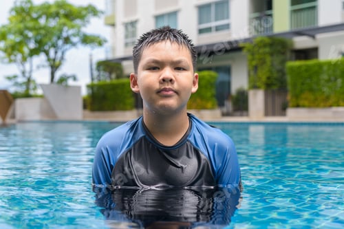 Preview: Teenage boy ready to swim in swimming pool