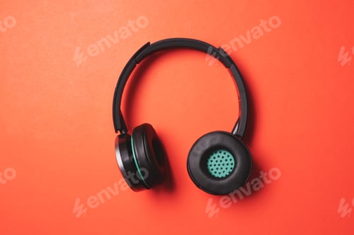 Preview: Modern headphones on a orange background.